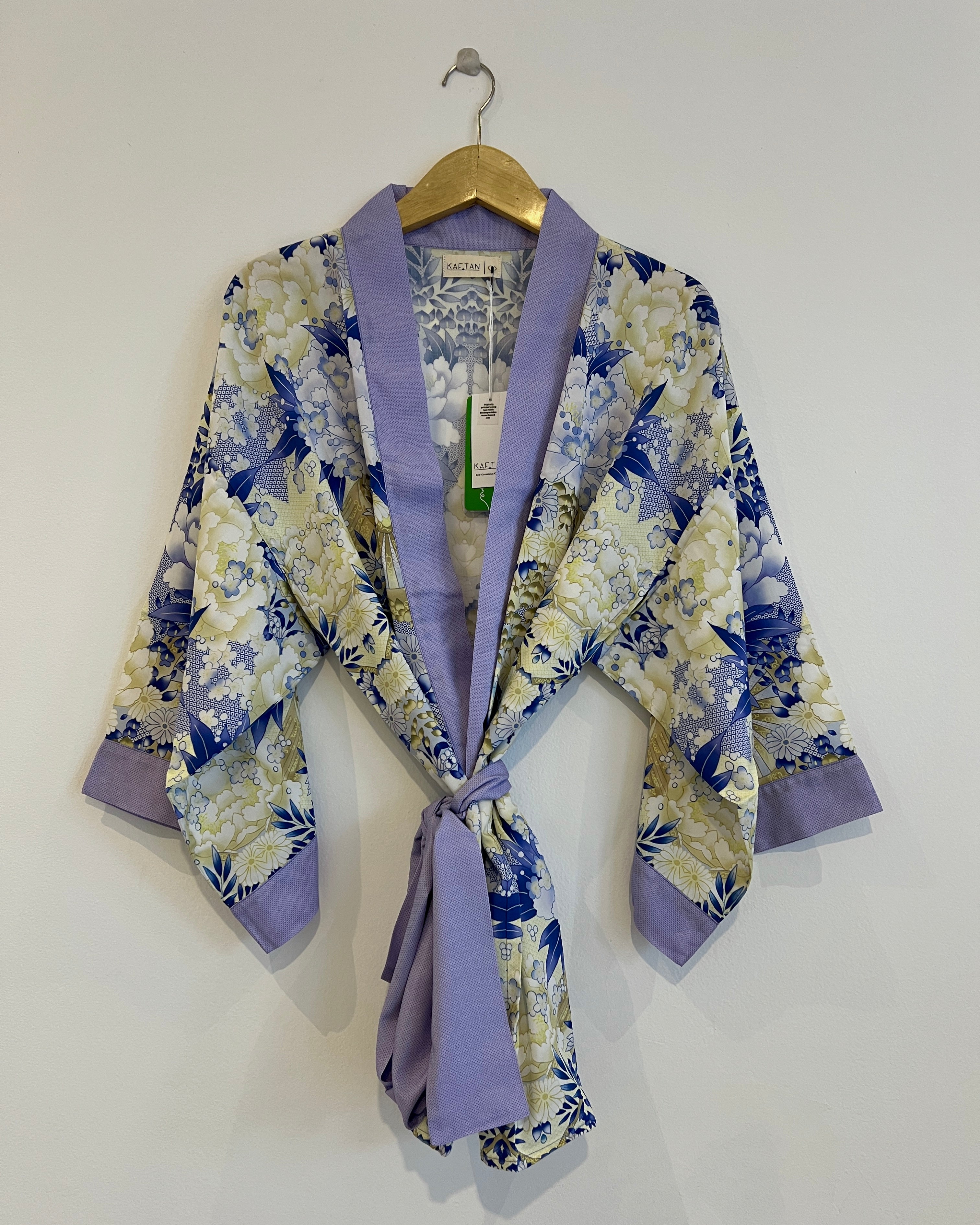 A digital print kimono robe with an blue and yellow floral pattern, displayed on a hanger against a white background.